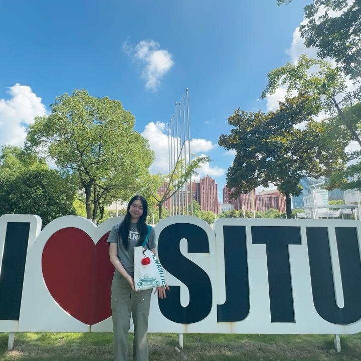 Student in front of I love SJTU sign